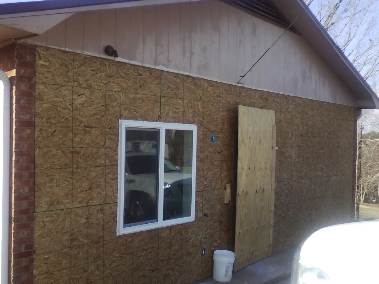 OSB sheathing on a garage addition wall before siding in Cleveland